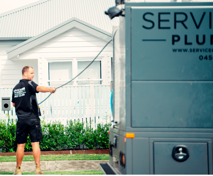 service one plumbing truck in front of a white house